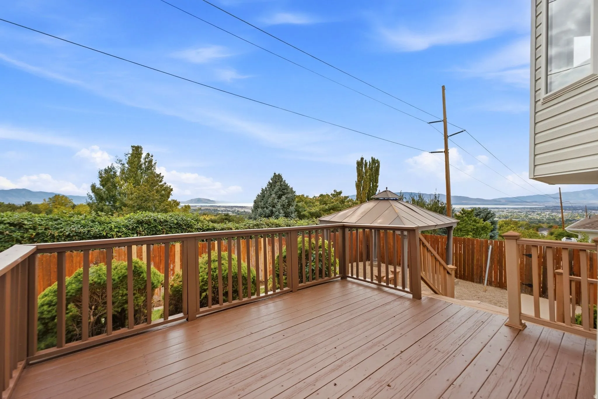 Freshly repainted back deck off of the dining room and kitchen with views of Utah Lake, Utah Valley, and the mountains. Very secluded backyard