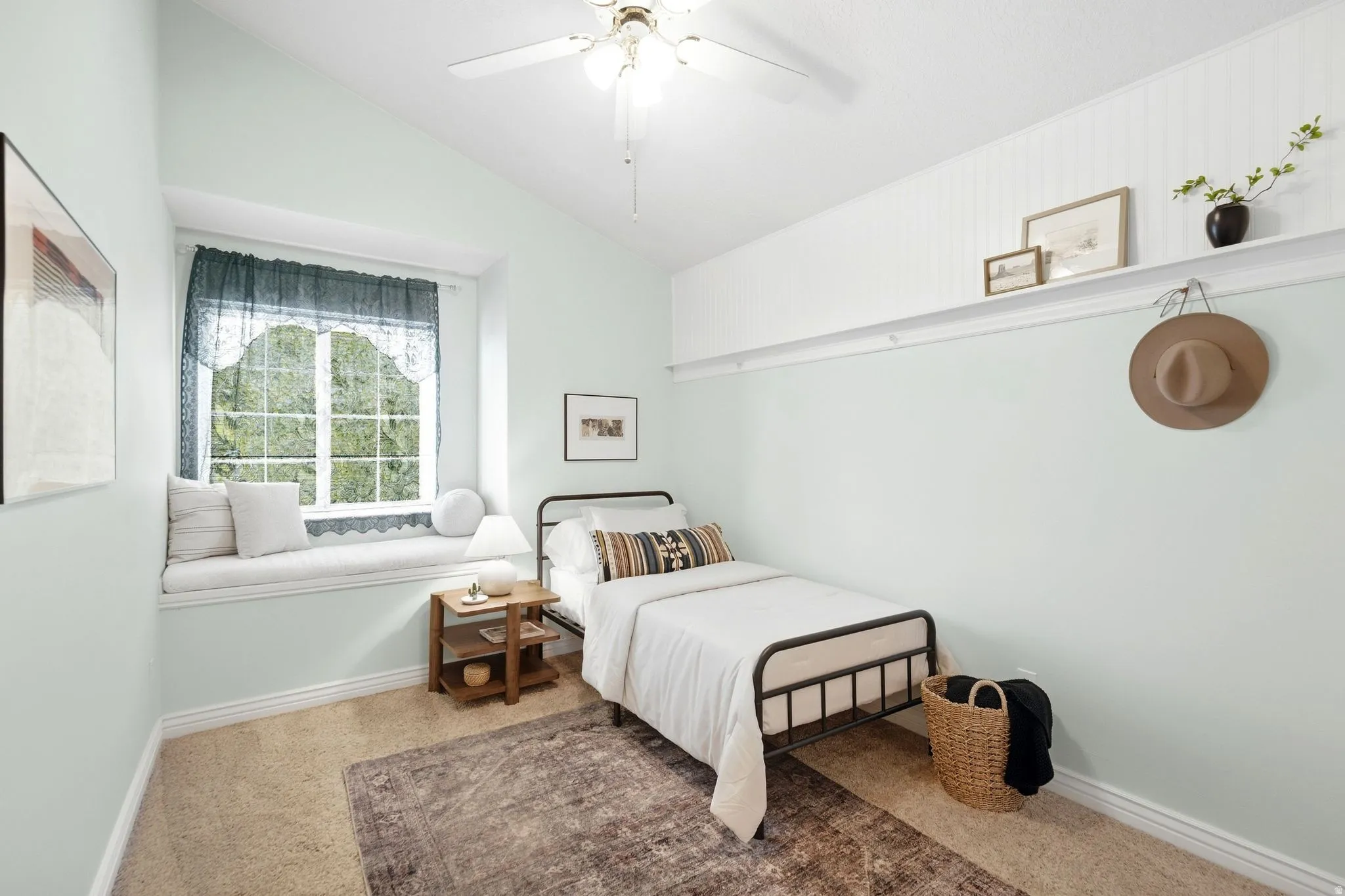 Third upstairs bedroom with vaulted ceilings, cozy window seat, and incredible mountain views