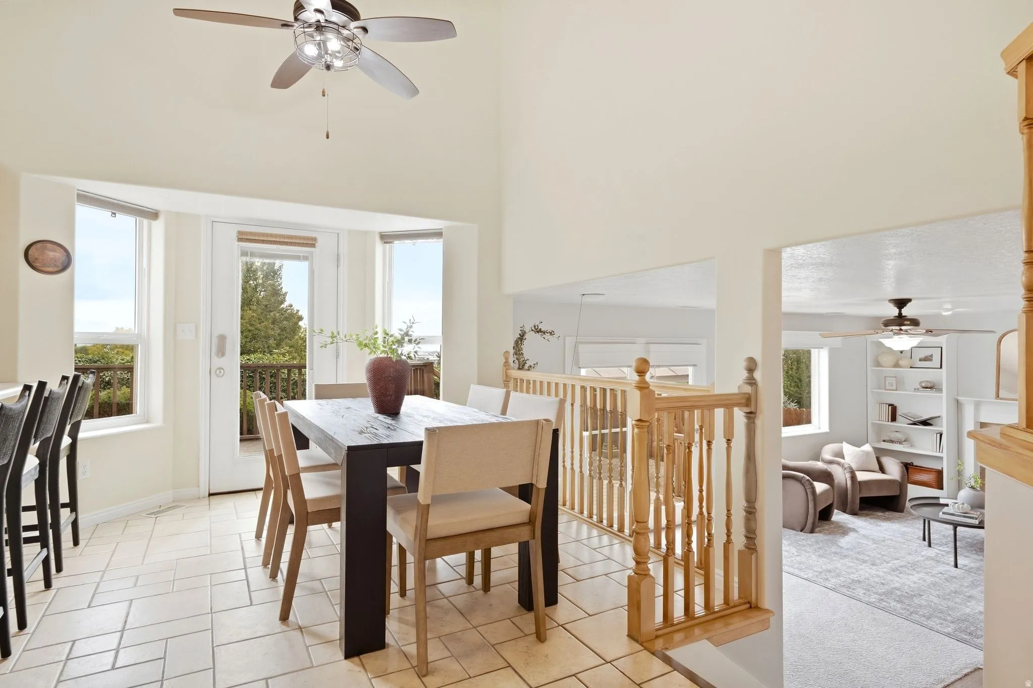 Dining area and view into the lower second living room with door access directly to the back deck. Stunning views and beautiful natural light.