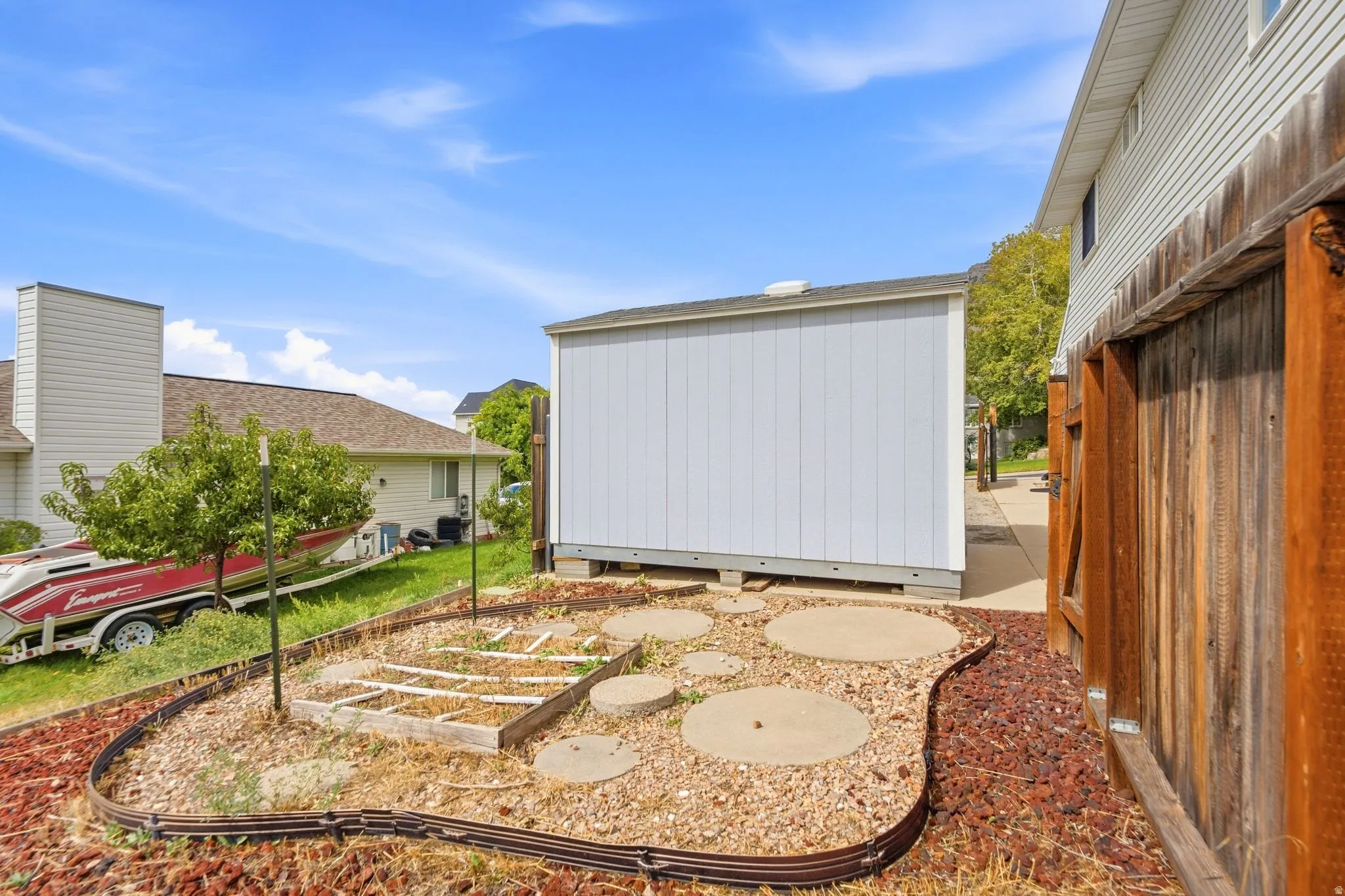 Garden beds to the west of the home, outside of the backyard gate