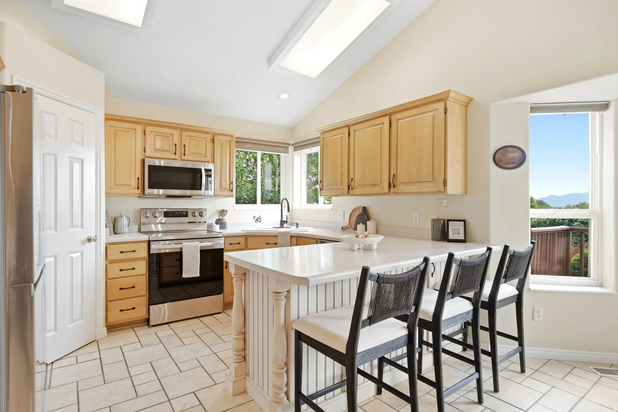 Kitchen, bar seating, and pantry view