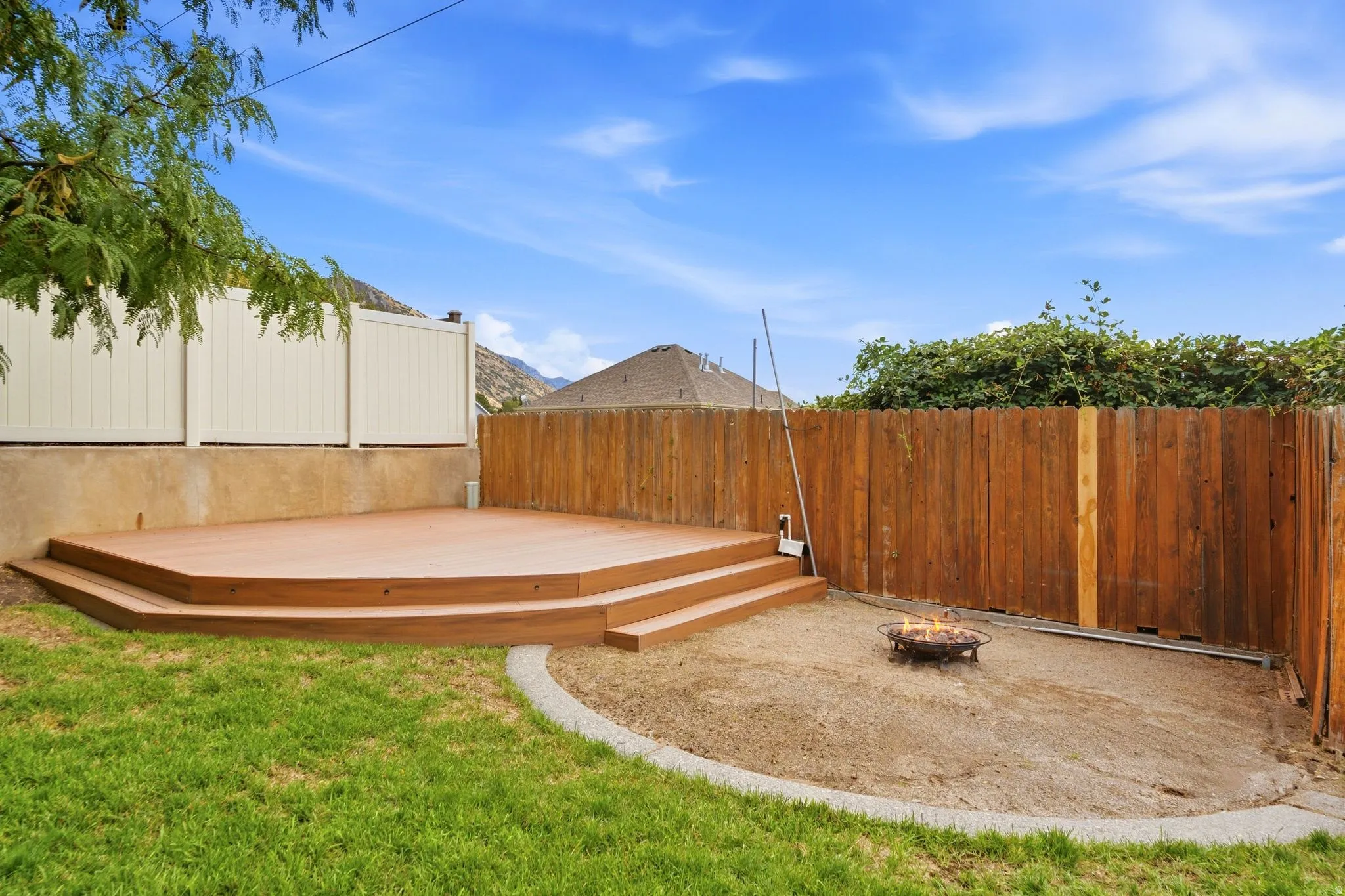 Additional elevated deck with lake and mountain views and a fire pit area for entertaining or enjoying quiet evenings at home