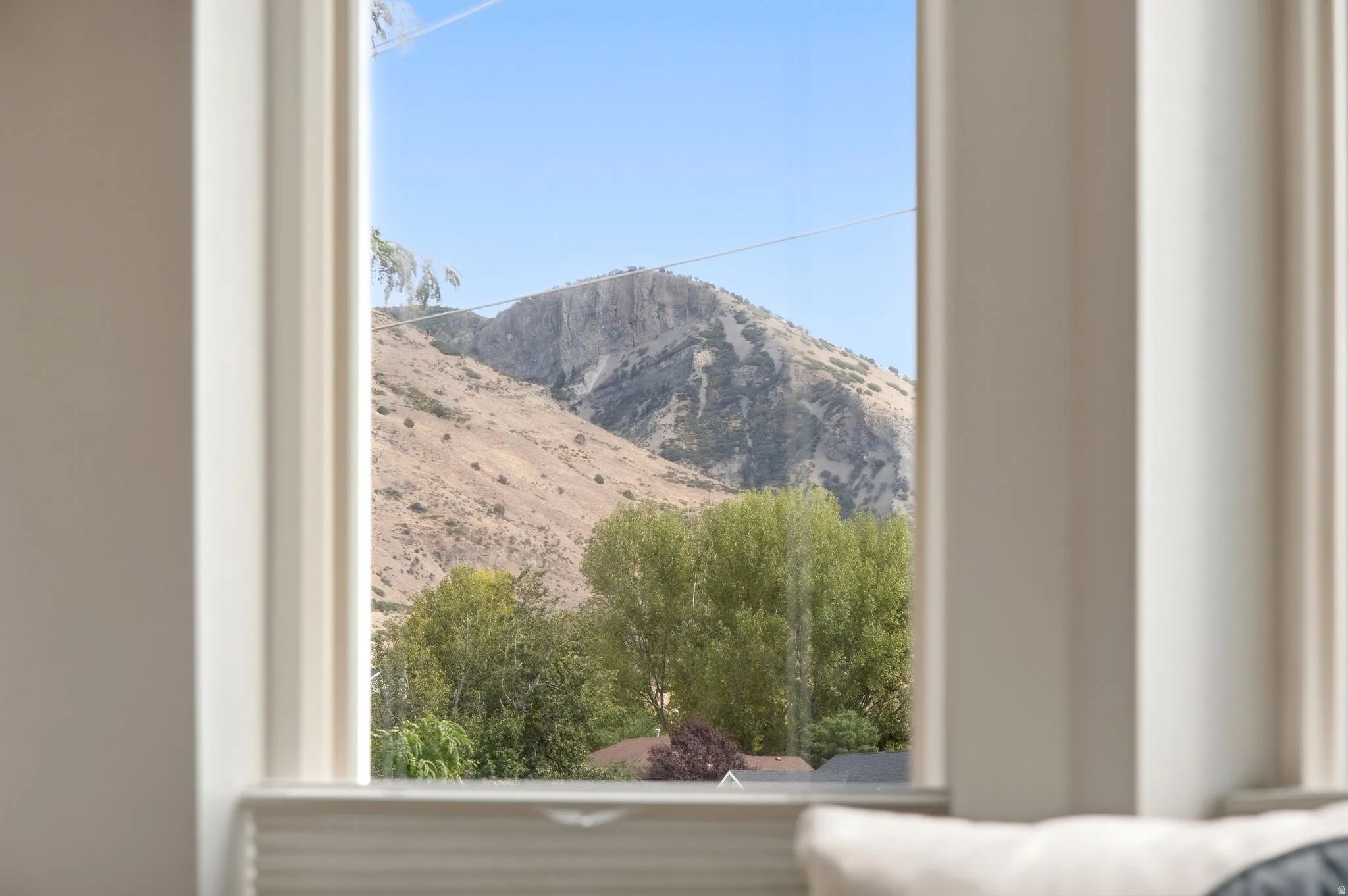 View from the bay window in the primary bedroom with incredible mountain and lake views.