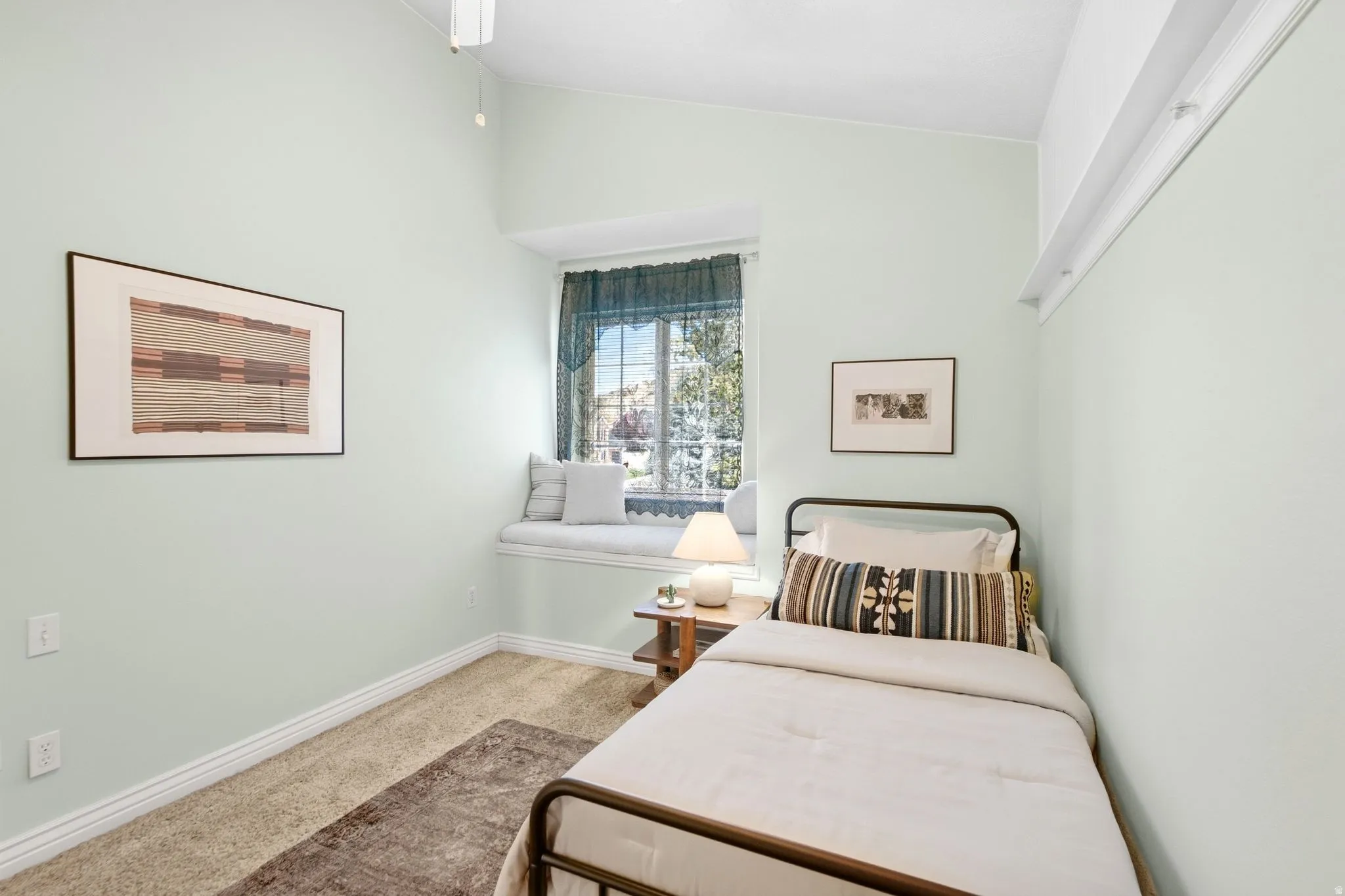 Third upstairs bedroom with vaulted ceilings, cozy window seat, and incredible mountain views