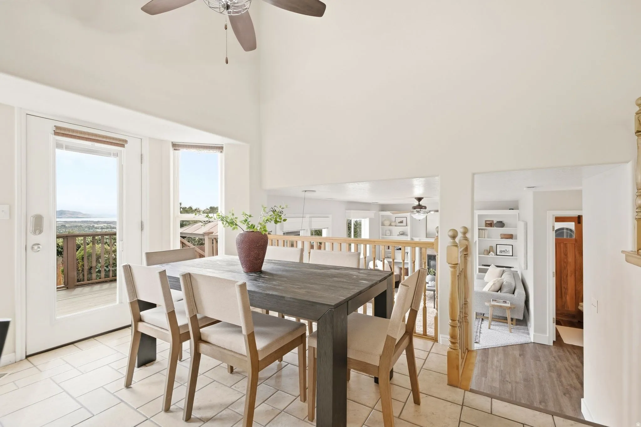 Dining area right off the kitchen island, looking over the lower living room and right next to the back door that leads you onto the deck