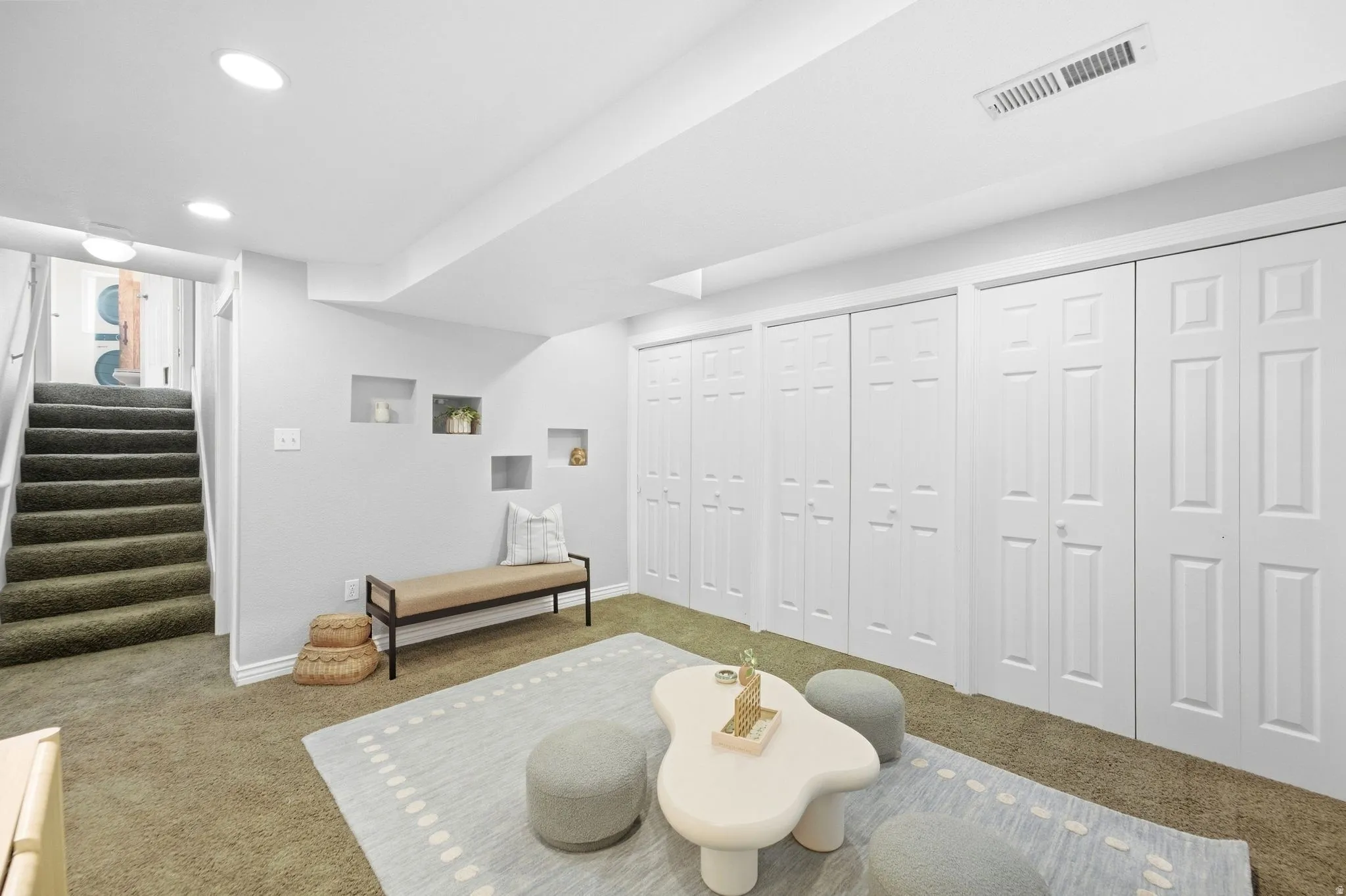 Basement living room with fresh paint, tons of storage, and full egress windows