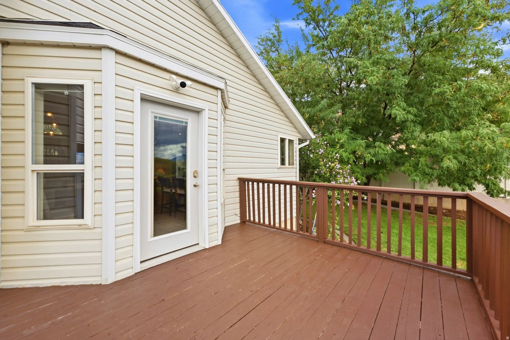 View of the back deck showing the entrance into the dining room and kitchen area