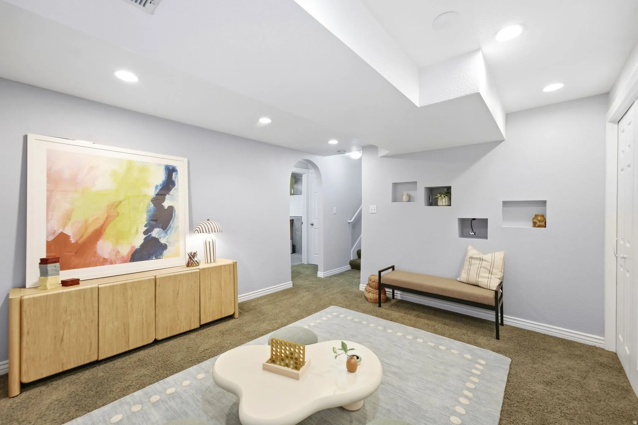 Basement living room with fresh paint, tons of storage, and full egress windows