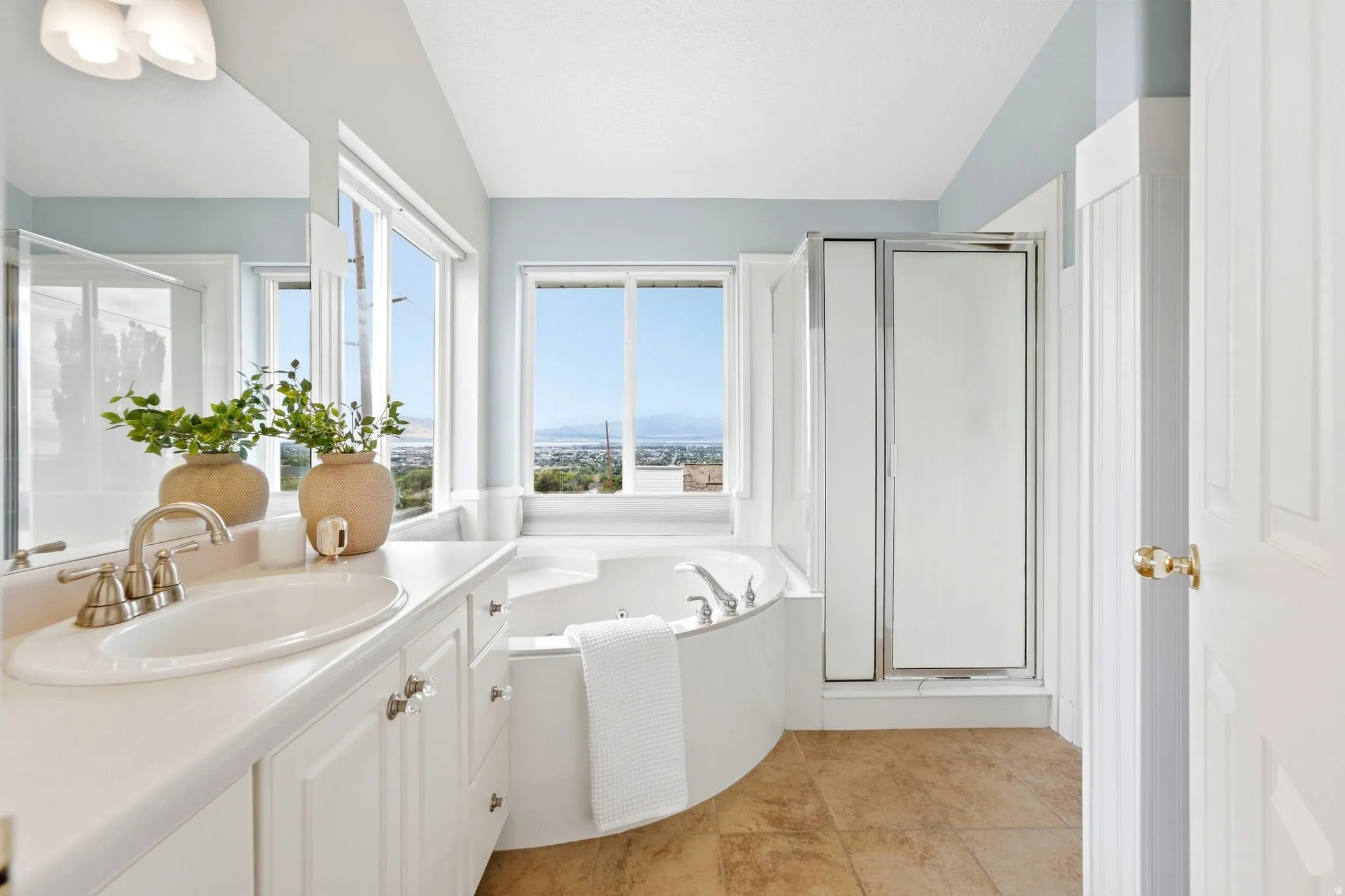 Ensuite primary bathroom with a separate corner soaking tub with spectacular views (Imagine taking a bath and watching the sunset here), separate shower.