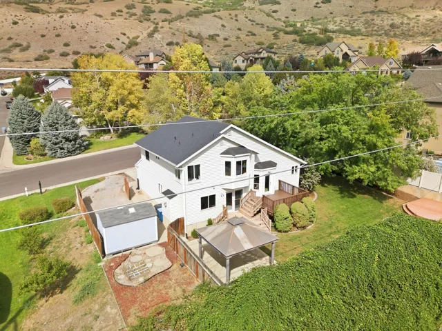 Back exterior view of the home and the yard