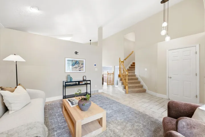 View from the front living room, looking back at the coat closet near the entry and going upstairs