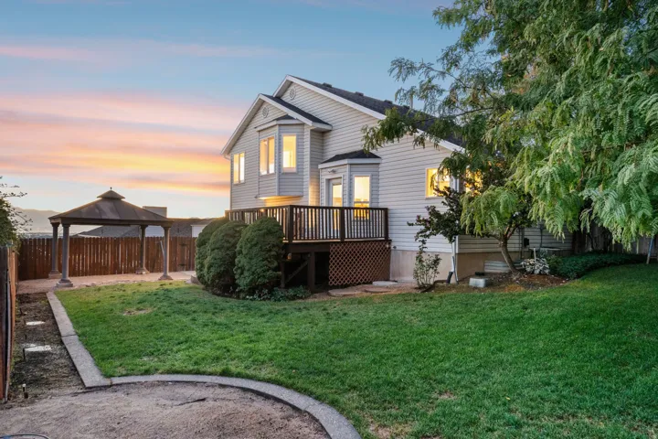 Back view of the home and yard at twilight