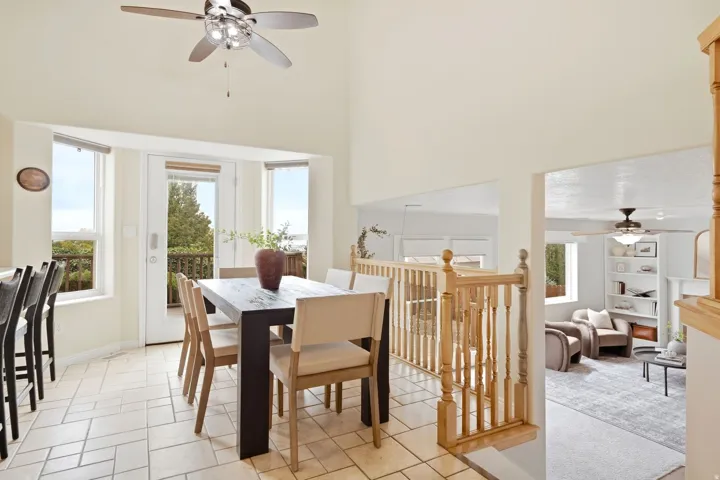 Dining area and view into the lower second living room with door access directly to the back deck. Stunning views and beautiful natural light.