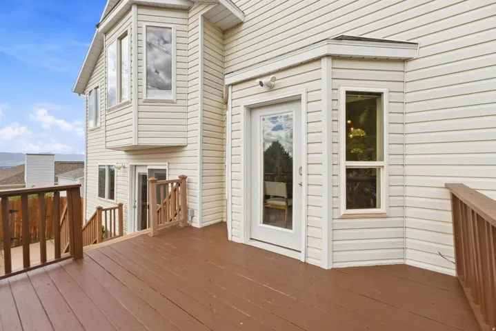 View of the back deck showing the entrance into the dining room and kitchen area
