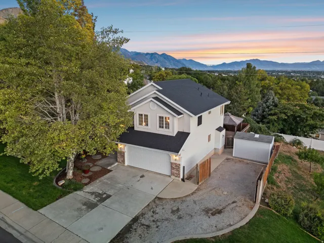 Front exterior of the home during twilight. Incredible 360-degree views from nearly every window in the home.  Views of the mountain, Utah Valley, and Utah Lake.  - Must see in person!
