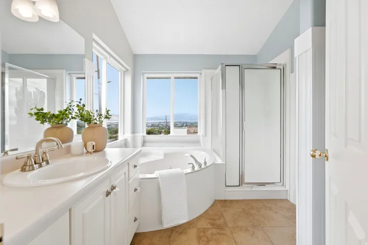 Ensuite primary bathroom with a separate corner soaking tub with spectacular views (Imagine taking a bath and watching the sunset here), separate shower.