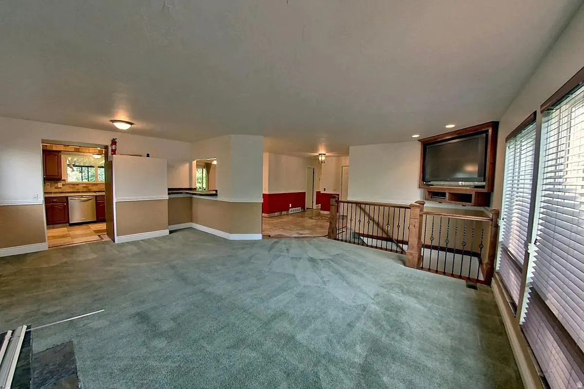 Kitchen with wood-finish cabinetry, stainless steel appliances, and tile flooring