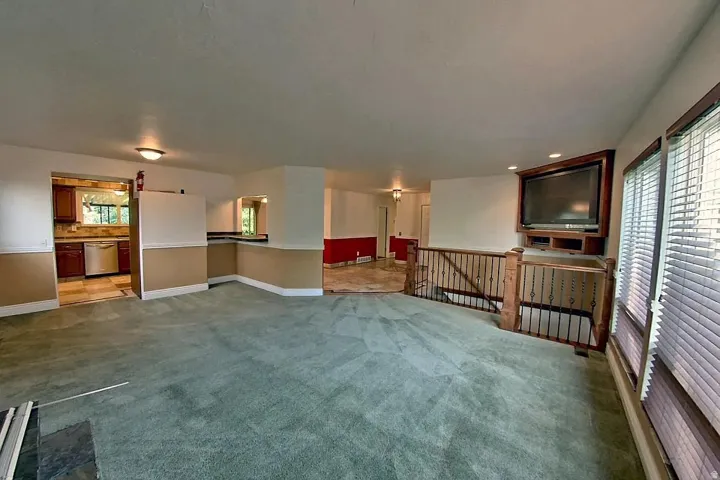 Kitchen with wood-finish cabinetry, stainless steel appliances, and tile flooring