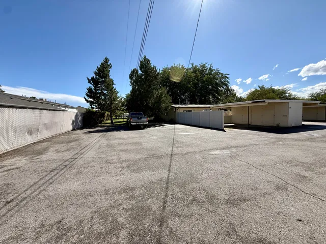 Visitor Parking behind listed property.  Paved lot offering ample parking space, bordered by a chain-link fence and mature trees