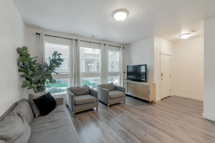 Light wood-finish flooring, white walls, and multiple ceiling-mounted light fixtures