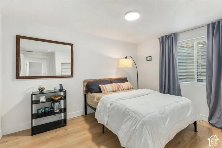 Light wood-finish flooring with white walls