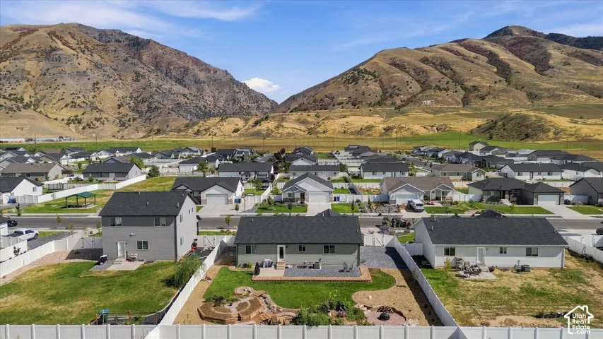 Newly constructed properties featuring dark shingled roofs and light-toned siding