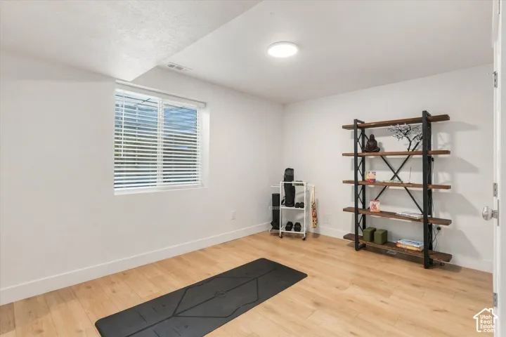 Recessed window, wood-finish flooring, built-in overhead lighting, white walls