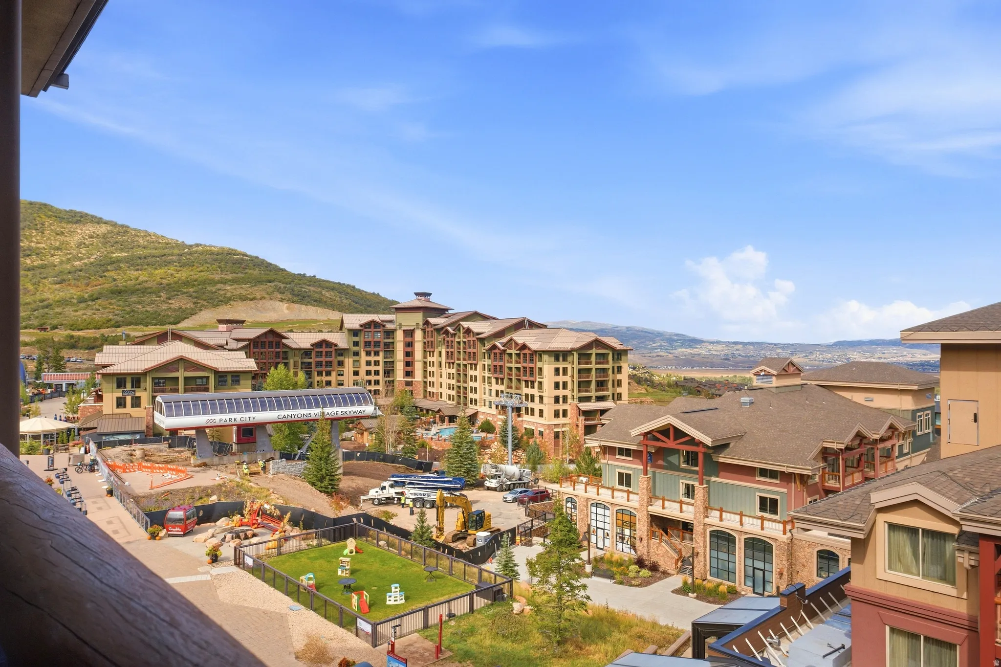 Mountain community setting featuring multi-story buildings, pitched roofs, and a gondola station