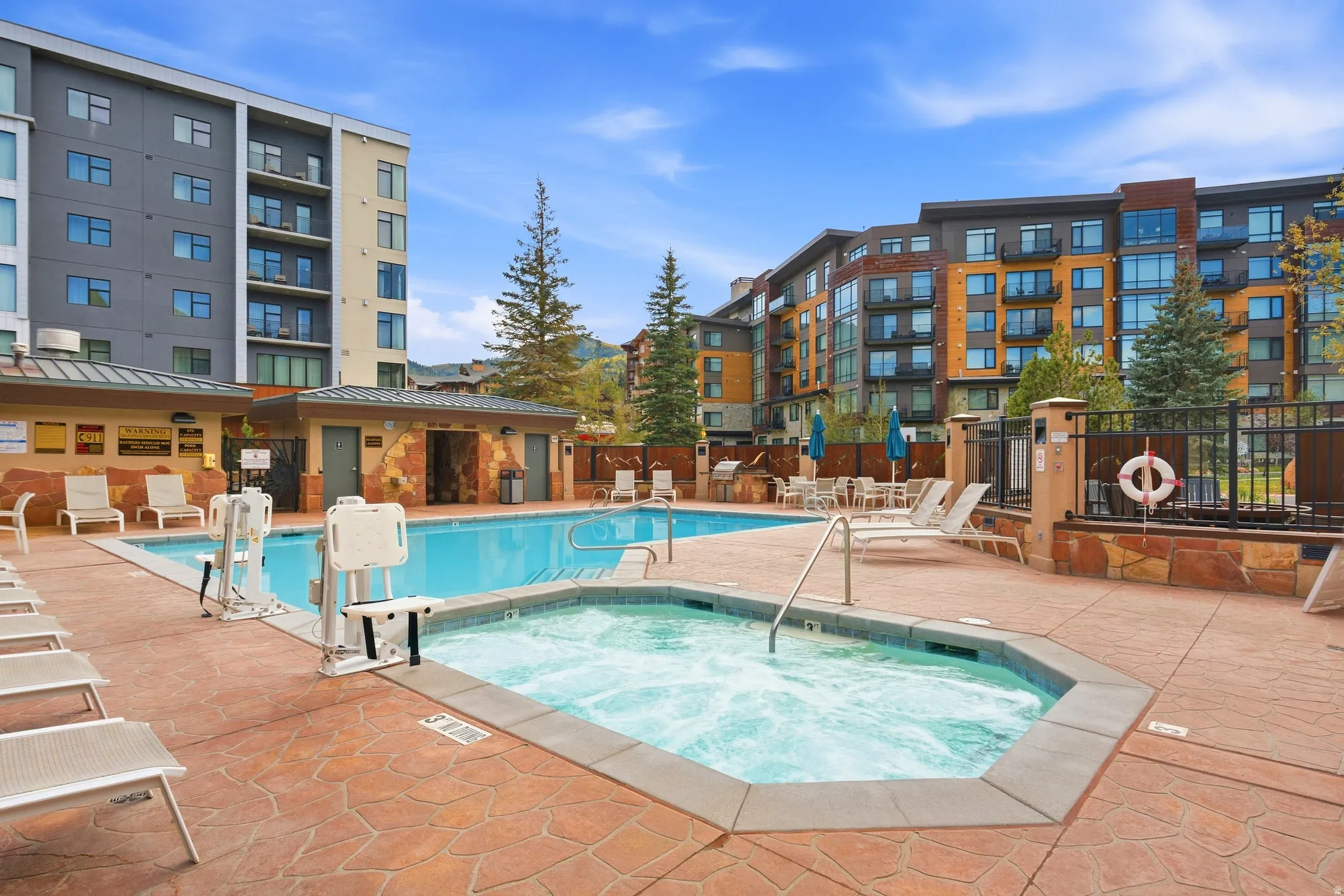 Outdoor swimming pool, integrated spa, and expansive paver deck