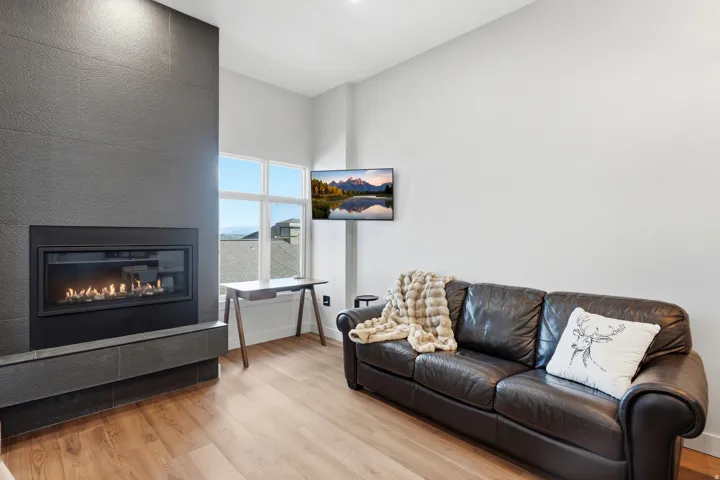 Contemporary fireplace with a dark tile surround