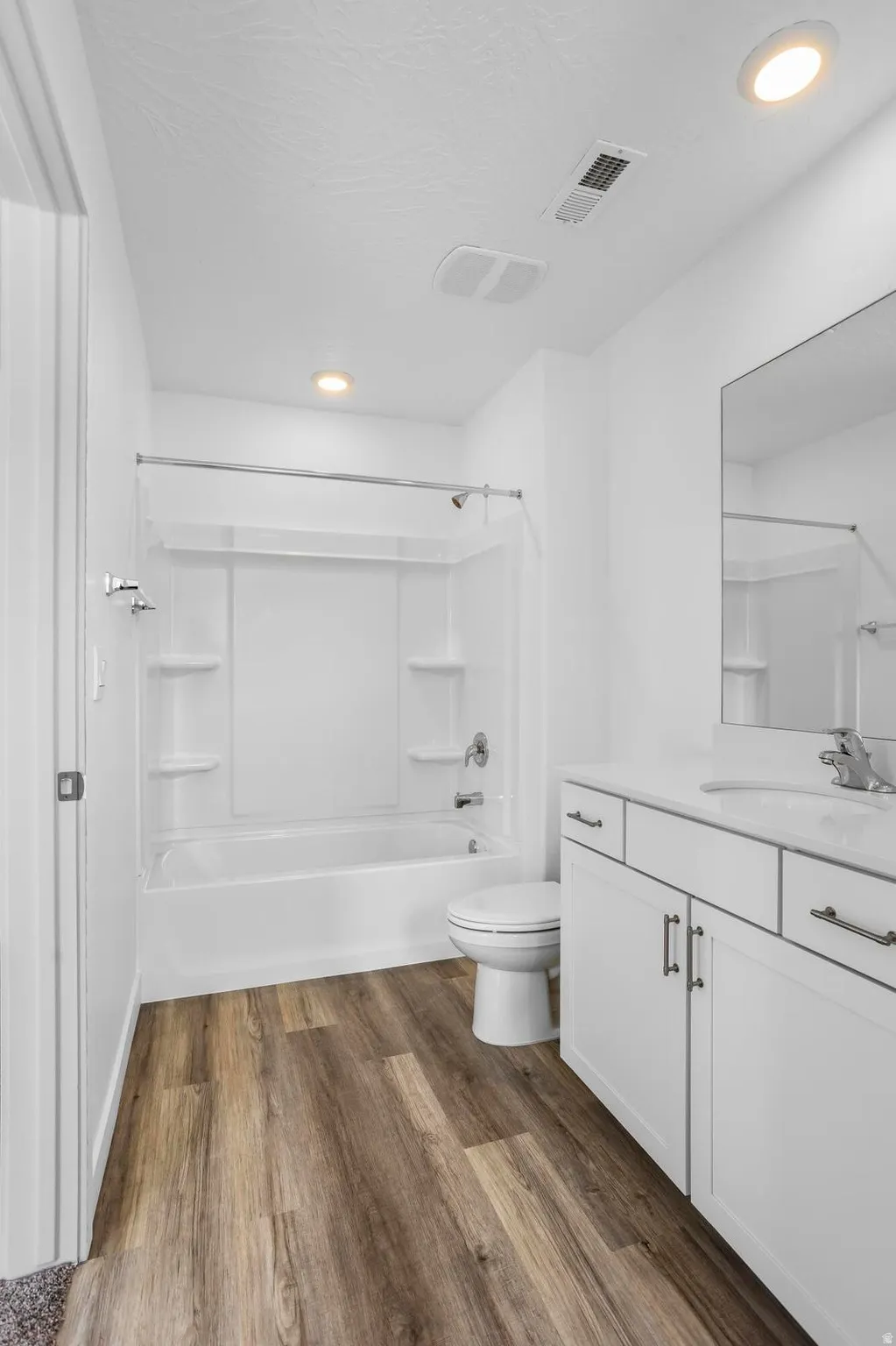 White vanity with an integrated sink and chrome fixtures