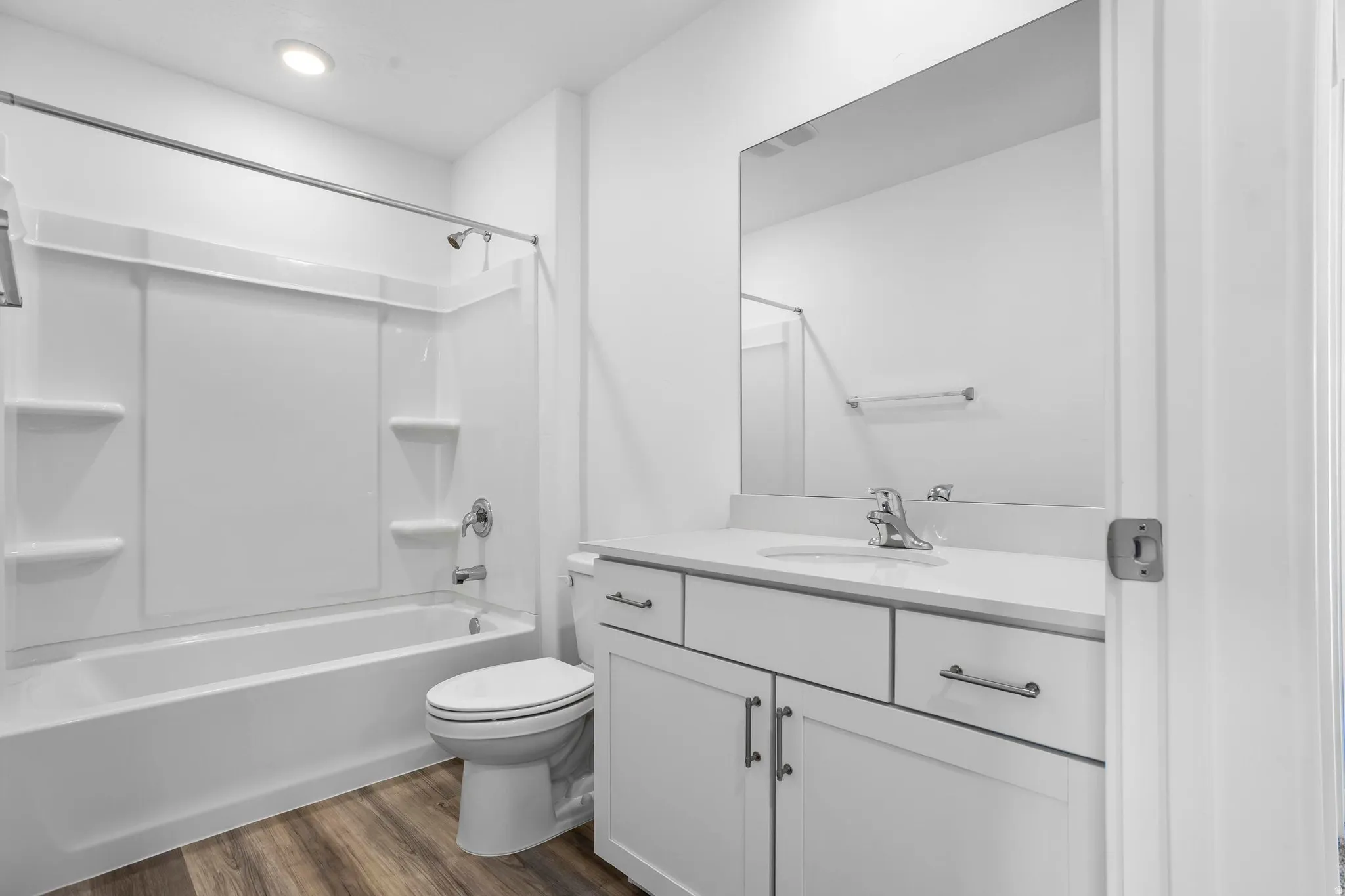 White vanity with brushed nickel hardware, white countertop, and integrated sink