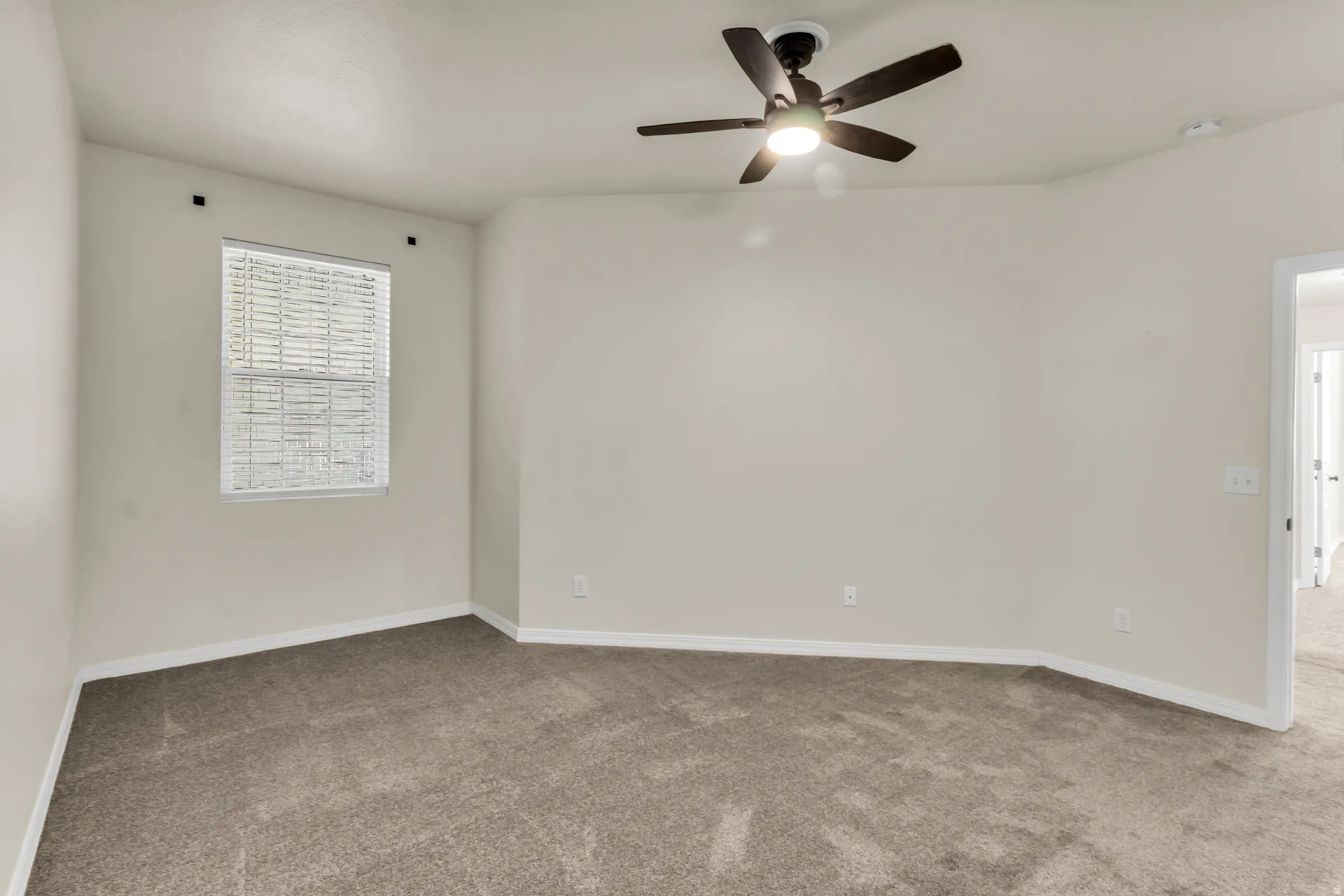 Primary Bedroom, featuring vaulted ceilings and fan.