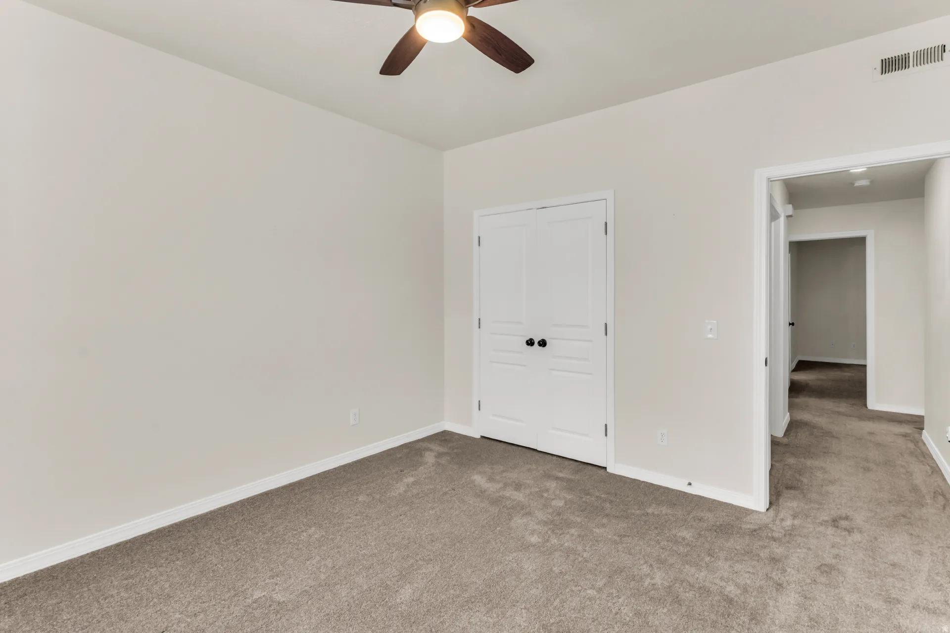 Bedroom 2, featuring vaulted ceilings and a fan.
