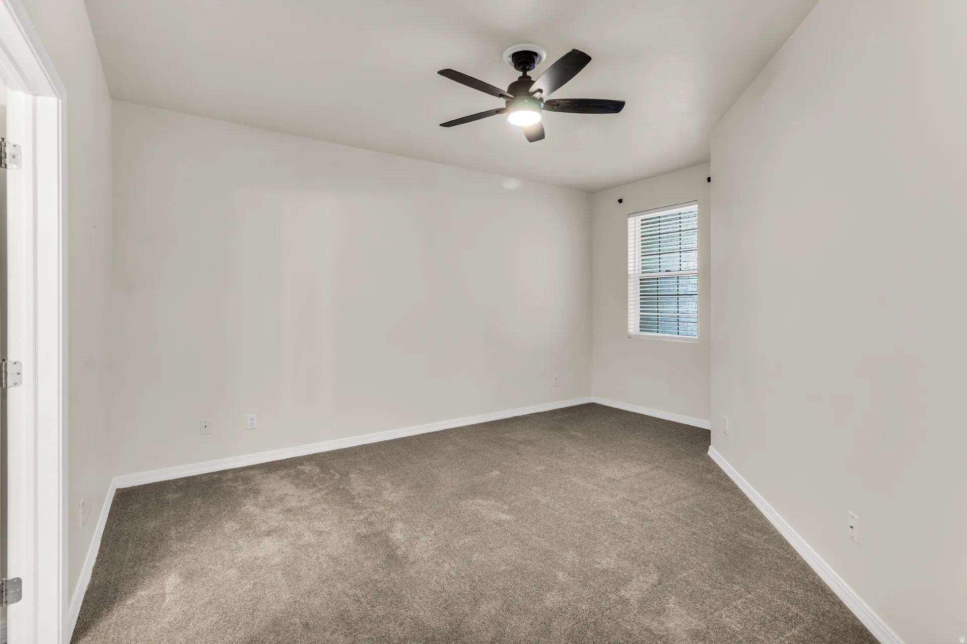 Spacious Primary Bedroom featuring vaulted ceilings and fan.