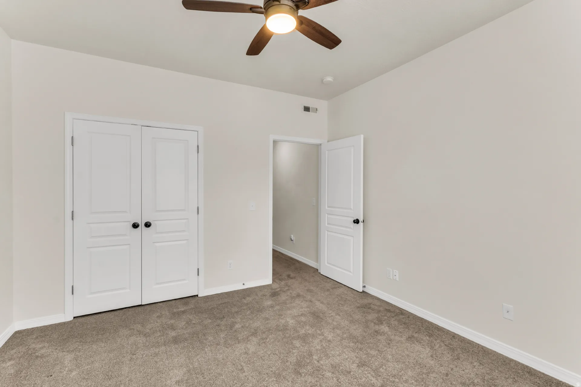 Bedroom 2, featuring a deep double-door closet.