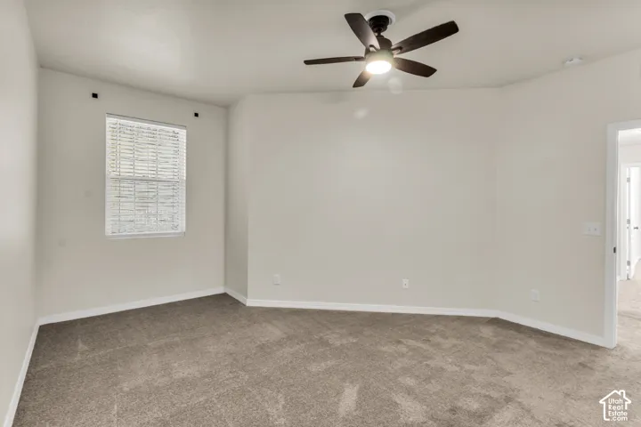 Primary Bedroom, featuring vaulted ceilings and fan.