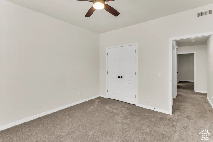 Bedroom 2, featuring vaulted ceilings and a fan.