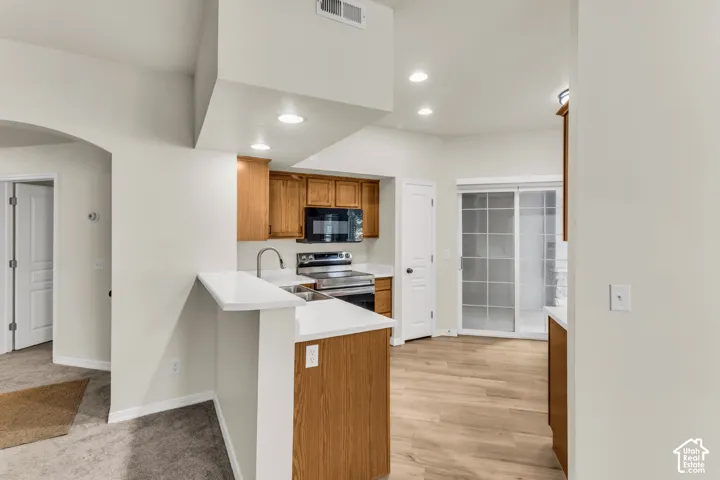 Kitchen view from dining area, patio is located outside sliding glass doors.
