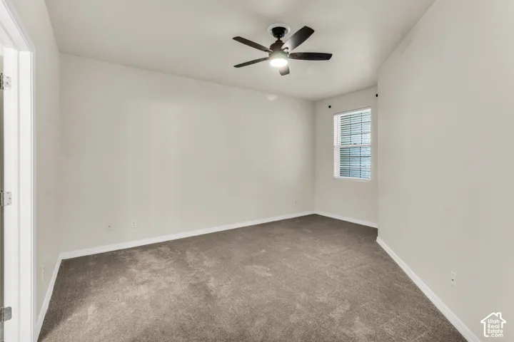 Spacious Primary Bedroom featuring vaulted ceilings and fan.