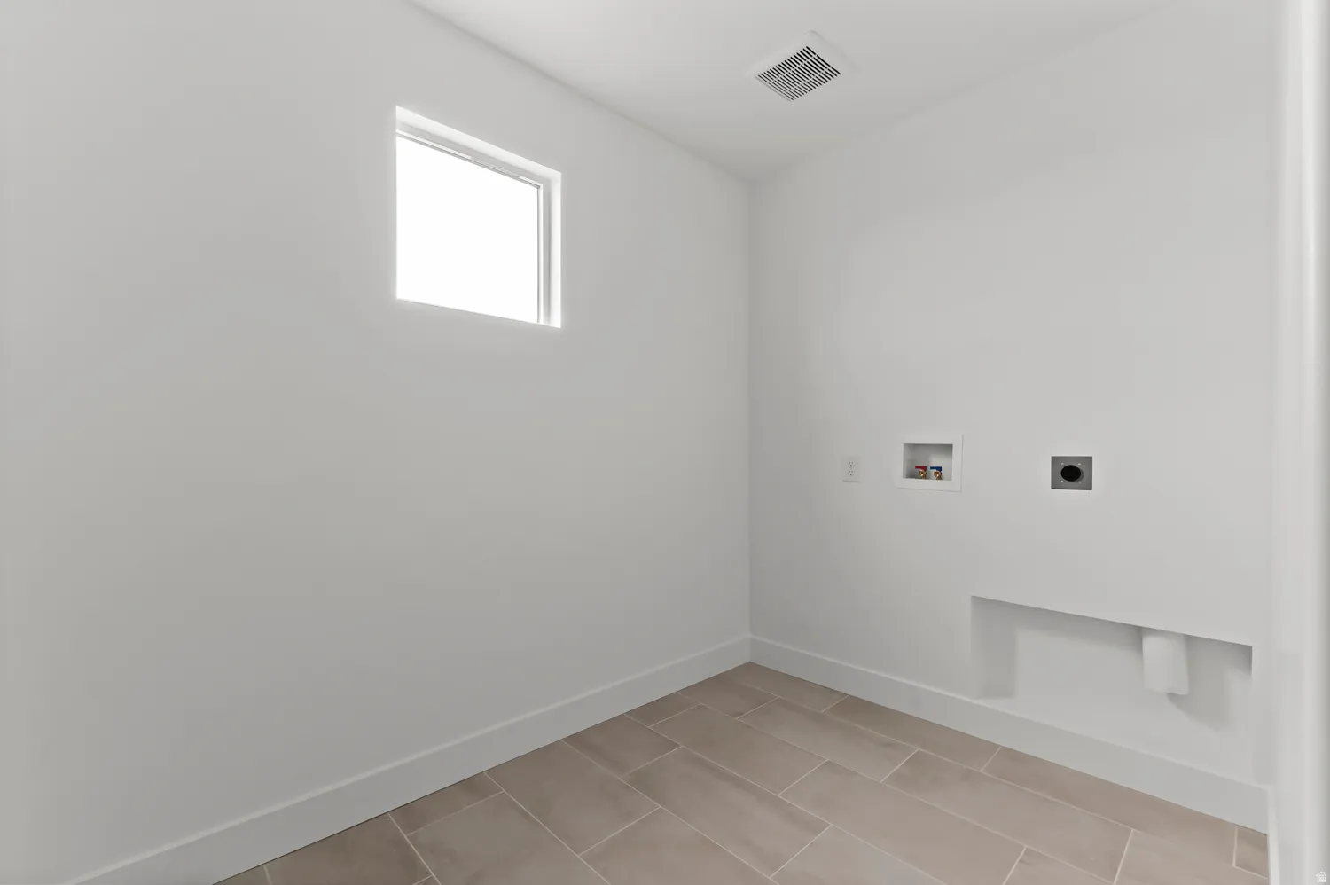Tile flooring, white walls, and a recessed window