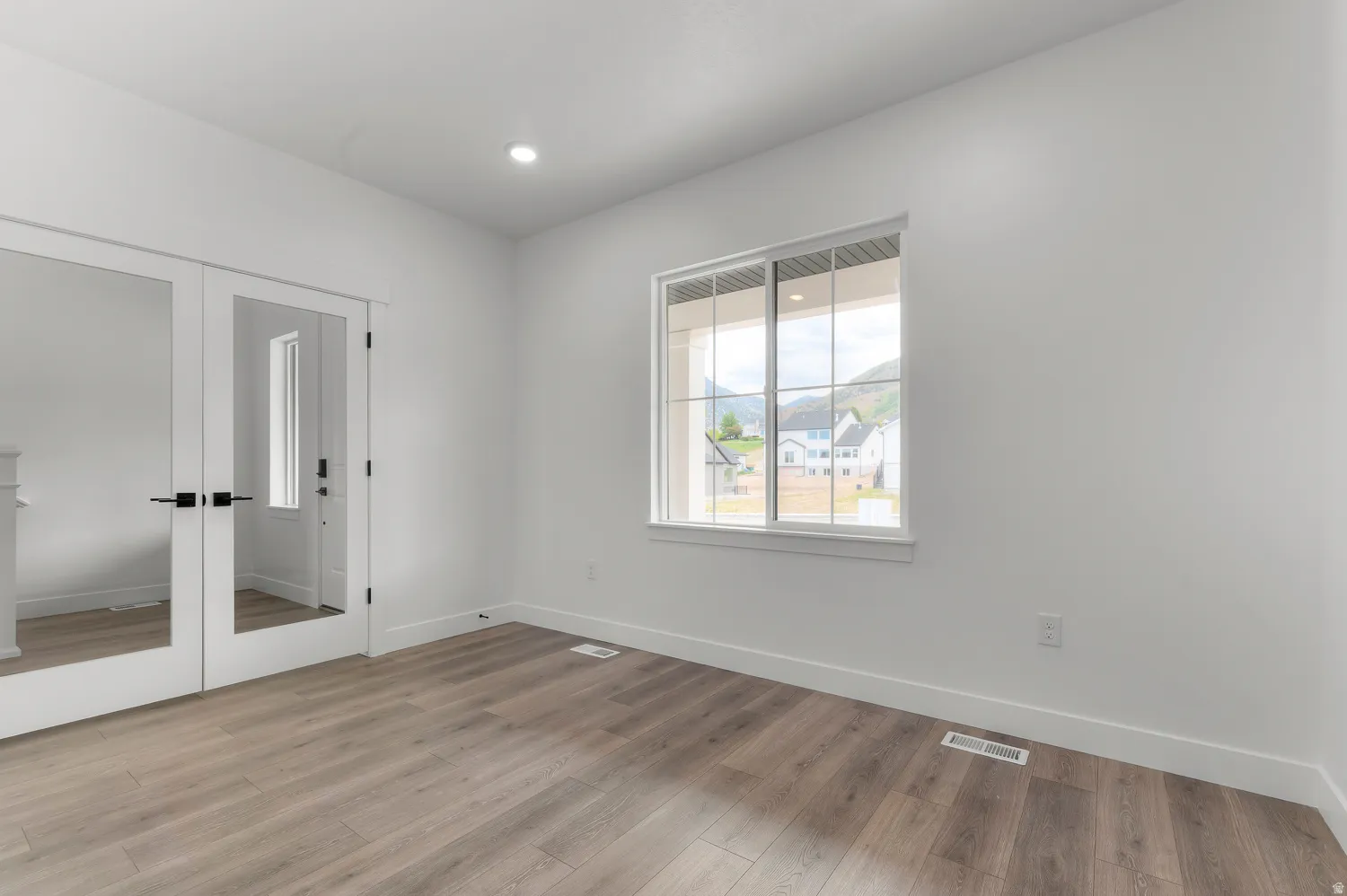 White interior walls with wood-finish flooring