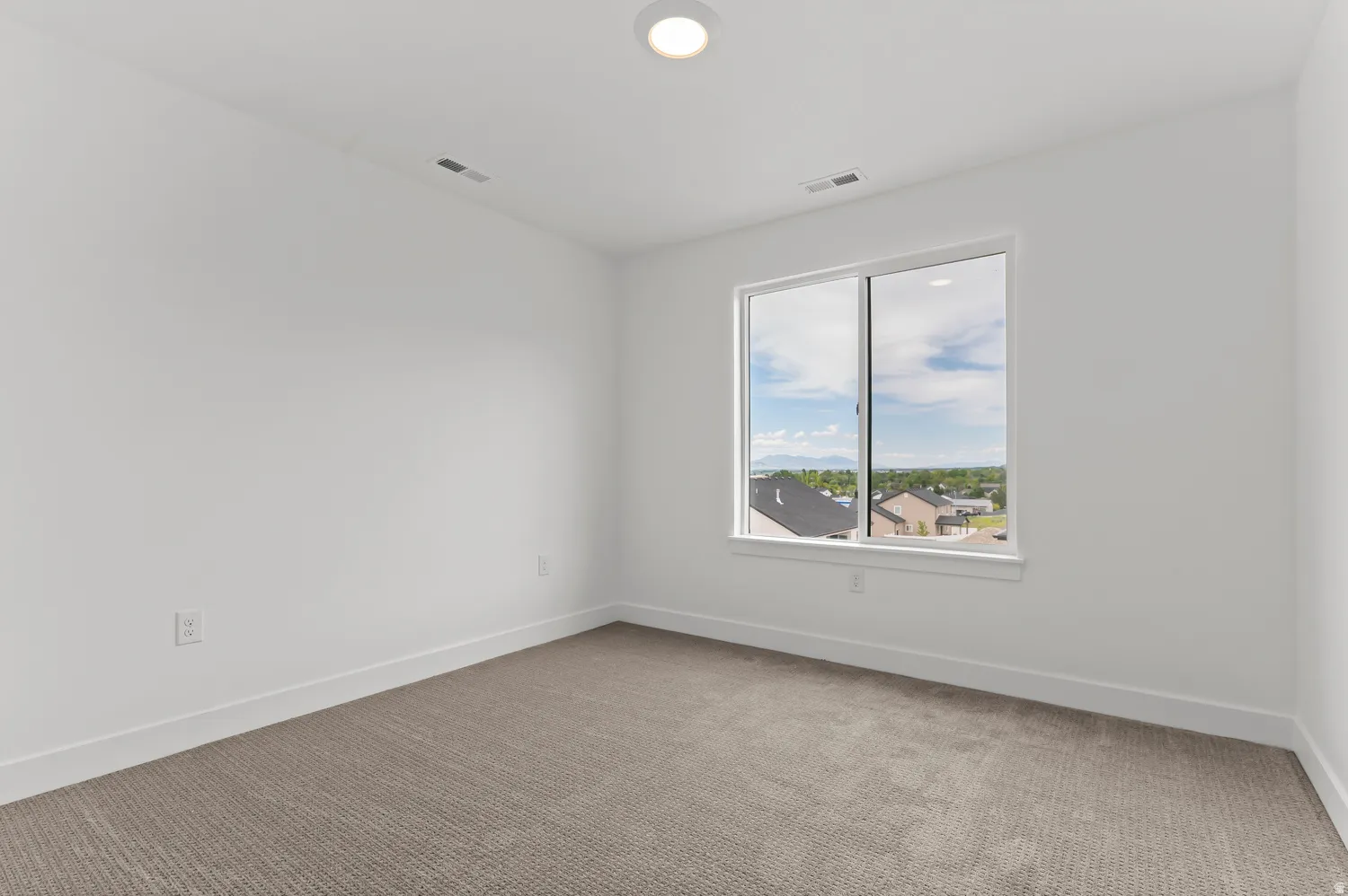 Neutral color palette with white walls and a gray carpet