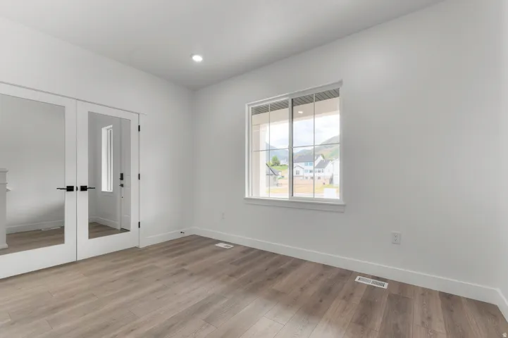 White interior walls with wood-finish flooring