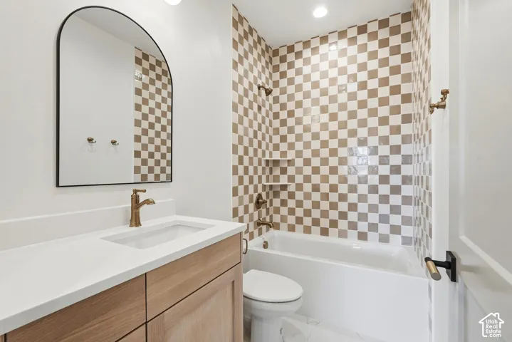 Bathroom with a single vanity featuring a wood-finish cabinet and white countertop