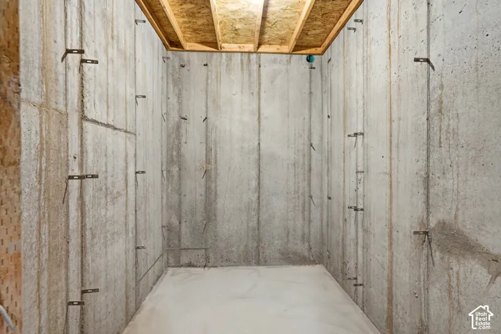 Concrete foundation walls with exposed wood ceiling joists