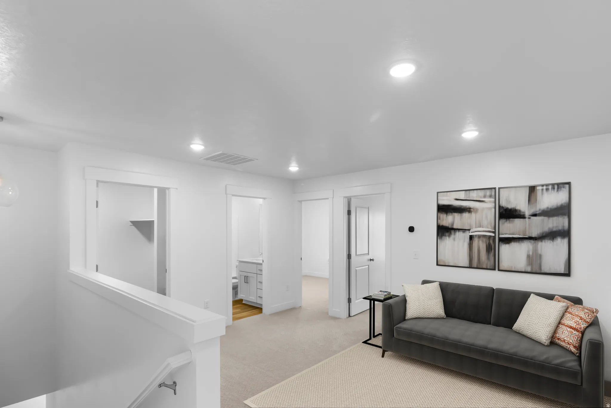 Carpeted landing area featuring recessed lighting, white trim, and a partial wall with railing