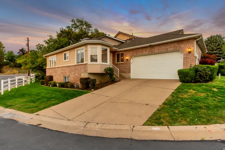Brick and stucco exterior with a prominent two-car garage