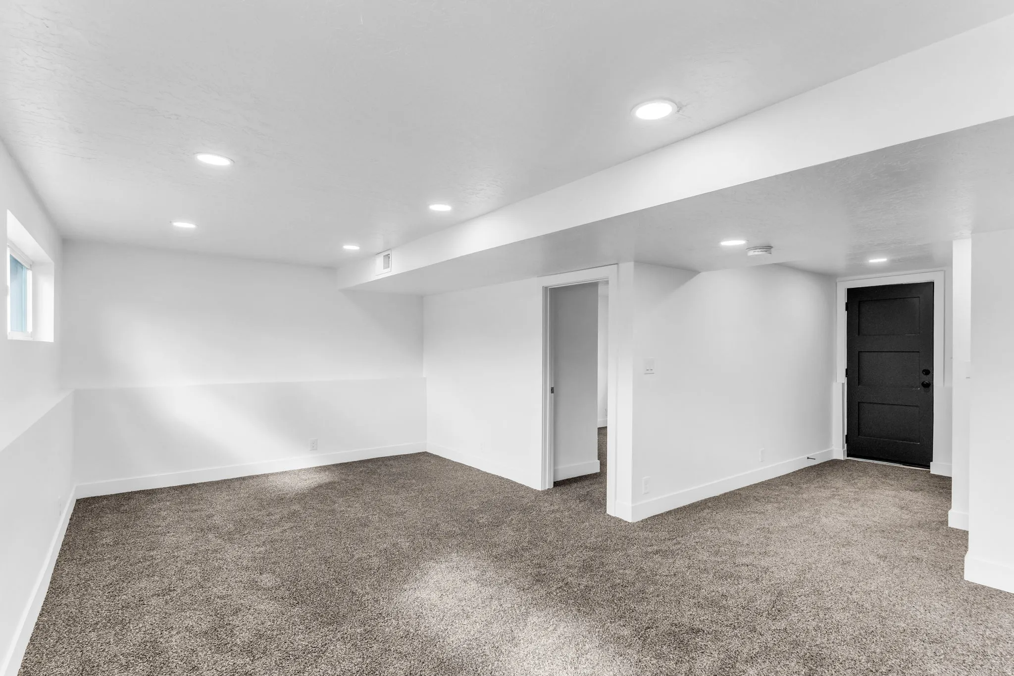 Expansive room featuring recessed lighting, a window, and plush carpeting