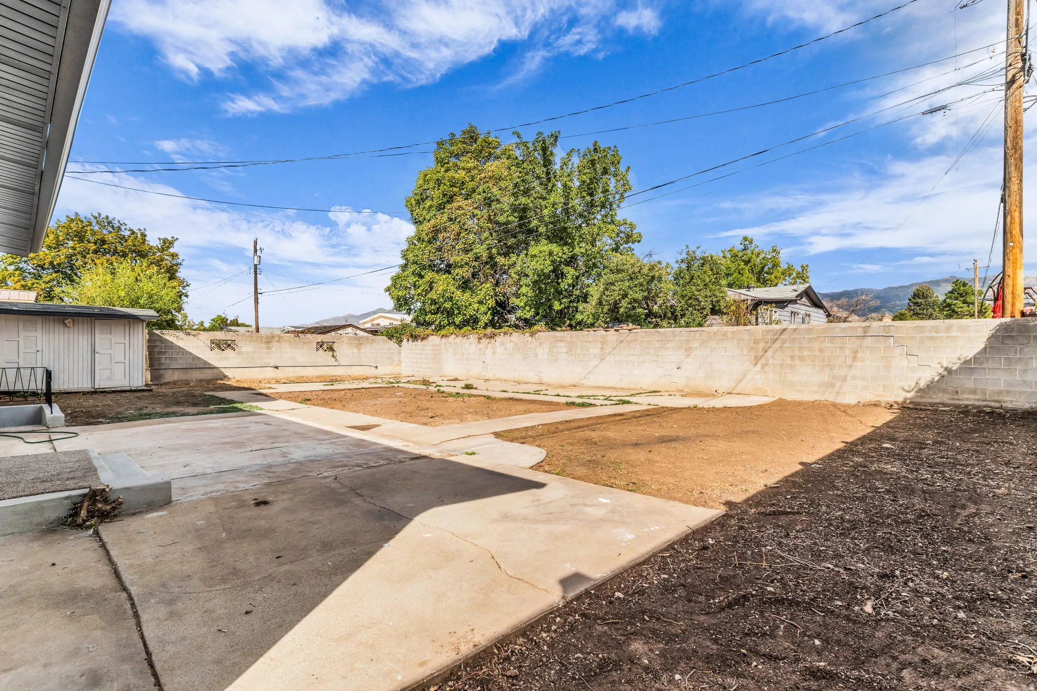 Expansive concrete patio with block wall perimeter